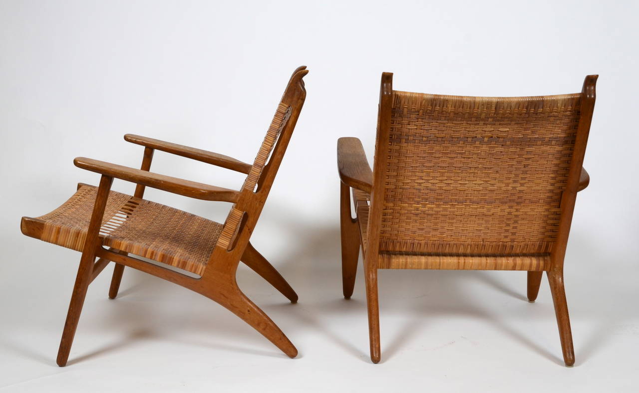 1 pair of easy chairs, model CH-27. Designed by Hans J Wegner for Carl Hansen & Son, circa 1951. In oak and rattan.