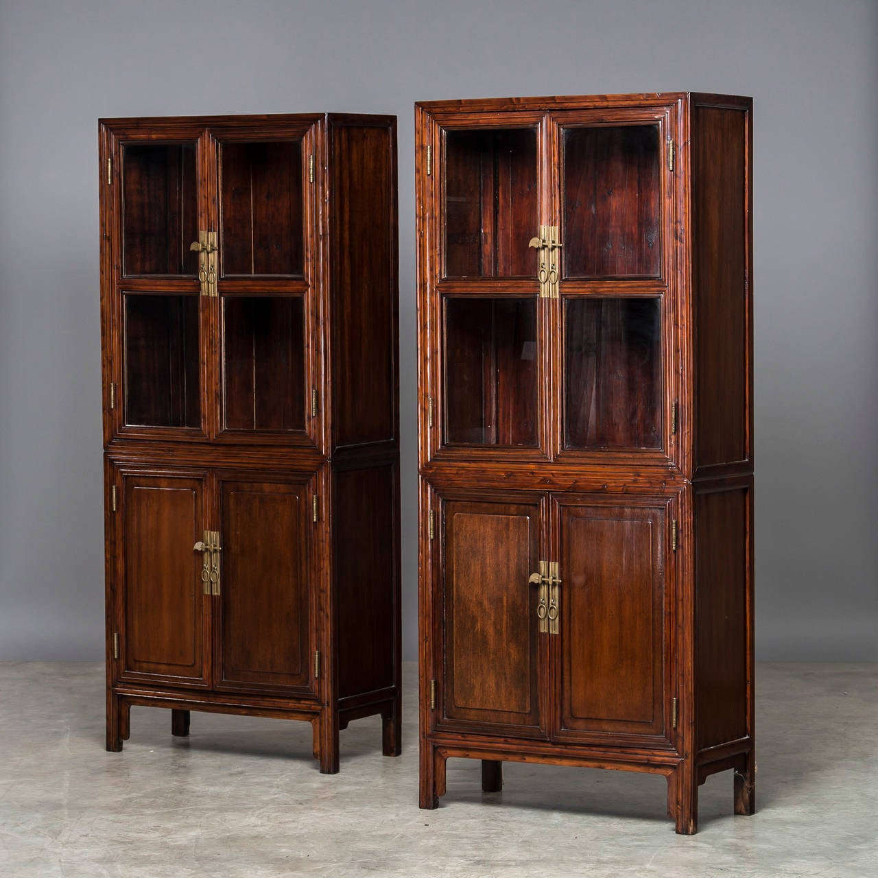 Pair of vitrines made of peachwood - at the top with a pair of glass doors, at the bottom with a pair of paneled doors, Jiangsu province from 1860 to 1880. The vitrines are in one piece. Sold as a pair for 7000 USD (Can be purchased individually)