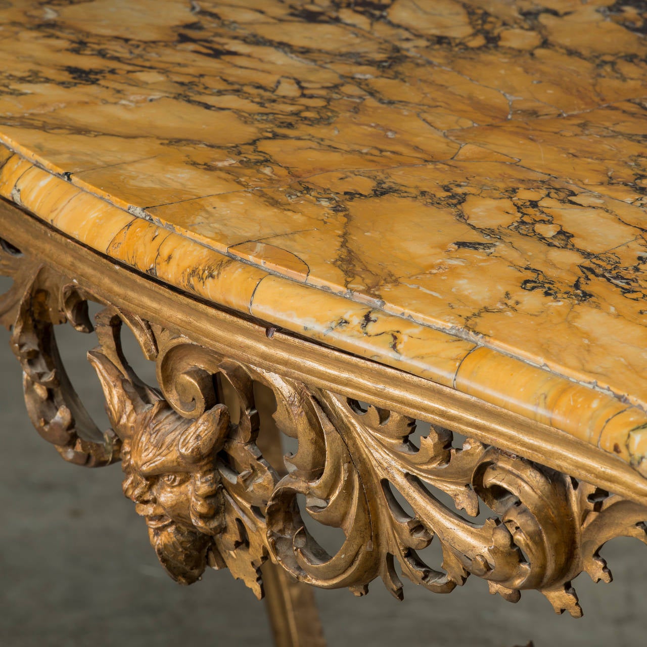 Italian console, wood carved and gilded, legs with a stretcher base with Putti in the middle. Exciting and decorative plate of 