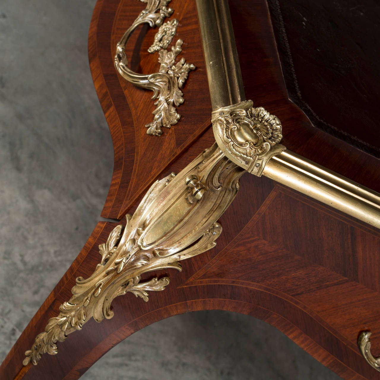 Desk (bureau plat), Napoleon III- or Rococo style. Walnut veneered with gilt bronze mounting on the tables edge and legs. The table top with leather. France about 1920.
