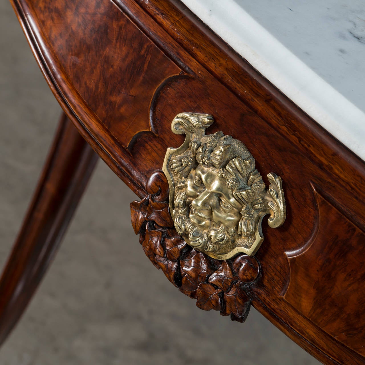 French console table in walnut. Drawer with gilt bronze in the form of a head. Cabriole legs with carving. White marble top with profiled edge, France, 1840-1860.