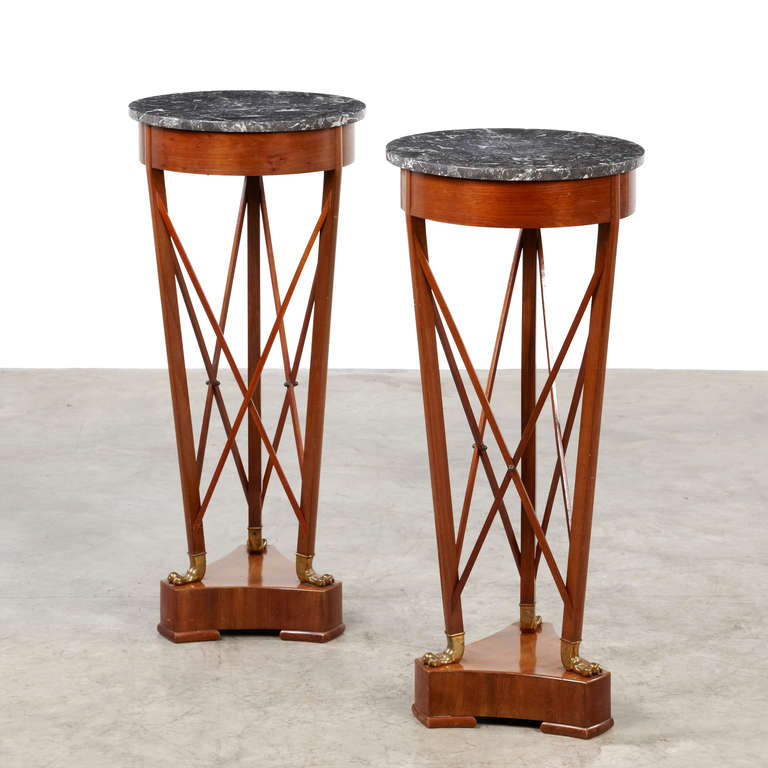 Pair of very elegant Art Deco pedestals crafted in mahogany with black-white varicoloured marble and paws in bronze. Denmark, c. 1920.