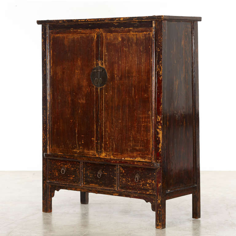 Large cabinet from the Shanxi province with original black lacquer which time has given a beautiful patina, further enhanced by the clear lacquer layer finished polish.<br />
Doors with three drawers below. A beautiful and exciting cabinet with a