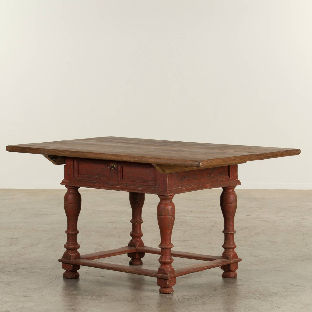 Original Baroque table with frameset in original red color and baluster turned legs with four stretchers. Tabletop in raw pine. The tabletop is locked to an imitated drawer.

Sweden, c. 1740-1760.