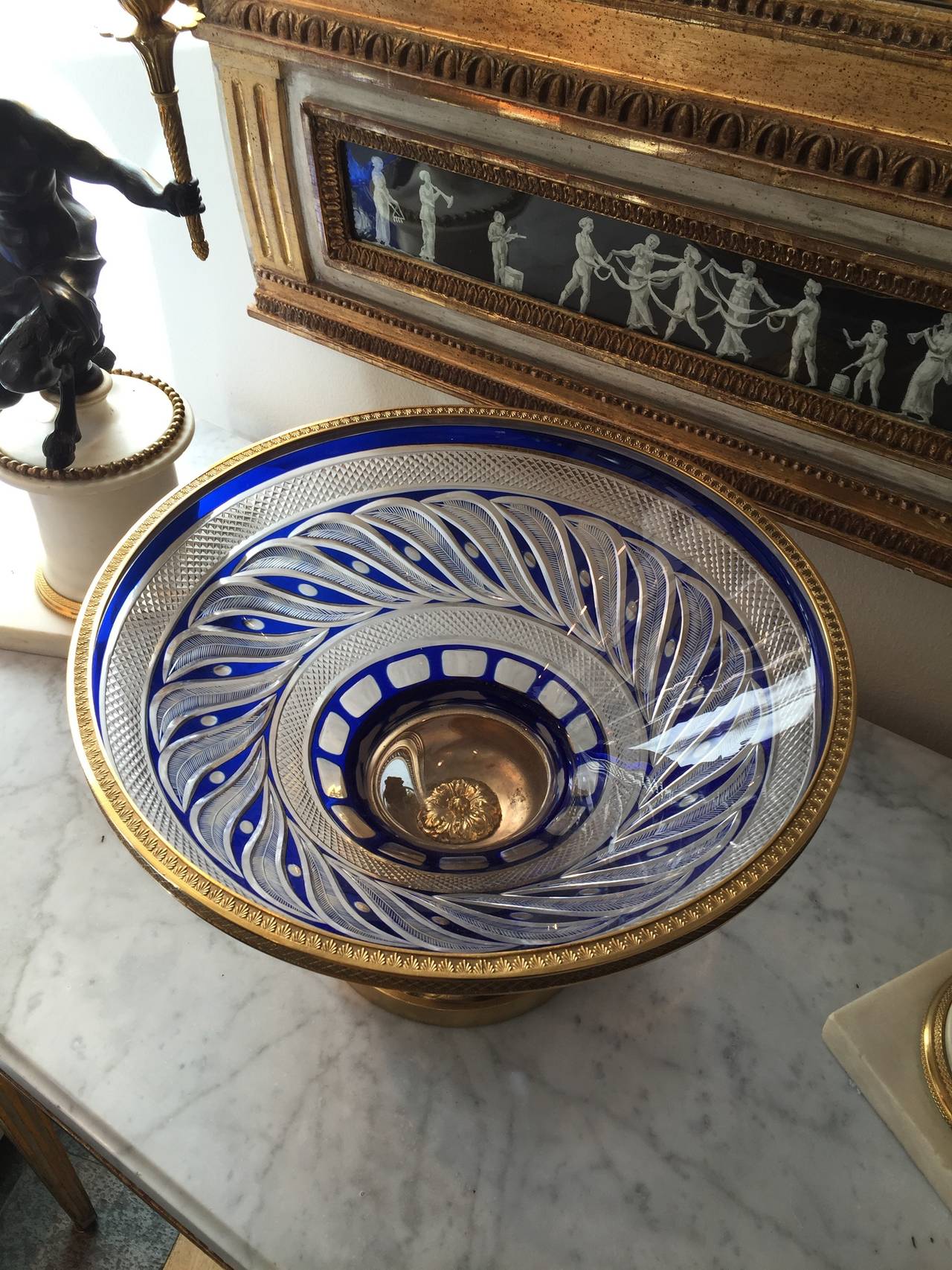 A RUSSIAN (IMPERIAL GLASS WORKS) CUT-GLASS TAZZA on a gilt bronze base.
Made around 1820-30.