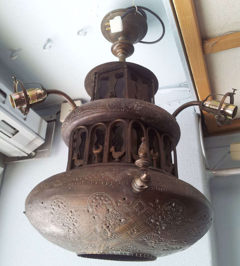 Oriental copper lamp, possibly Turkish or from the Arabic peninsula fitted with electrical lights, colored glass in parts oxidized copper foundation, some wear and minor damage.