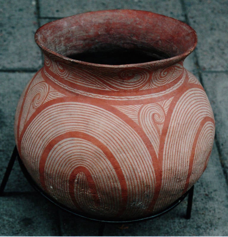 Ban Chiang terracotta round pot with orange red pigment, North Thailand.