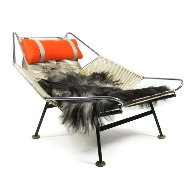 Hans J. Wegner Flag Halyard easy chair with original green painted steel frame, wooden shoes, orange neck cushion and a sheep skin. 

Designed By Hans J. Wegner in 1950 and manufactured by Getama, Denmark 1950s model GE225. 

Original condition
