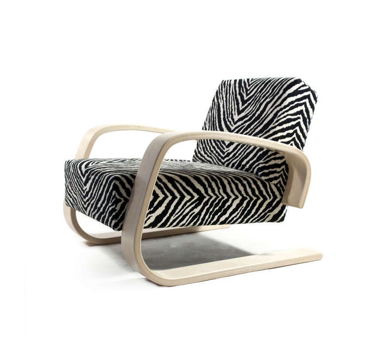 Alvar Aalto the 'Tank' with frame of birch, upholstered in Zebra fabric. 

Designed 1936 for the Milan Triennale,  manufactured by Artek, Finland, as armchair model 400. 

A fantastic majestic and comfortable chair. 

A pair is available,