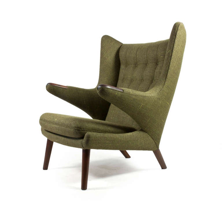 The Hans J. Wegner 'Papa Bear' chair in Rosewood. 

Designed 1951 and manufactured by AP Stolen, Denmark as model AP19.

New green fabric upholstery, executed as original. Arms of Rosewood, legs of rosewood stained beech. 

We do always have