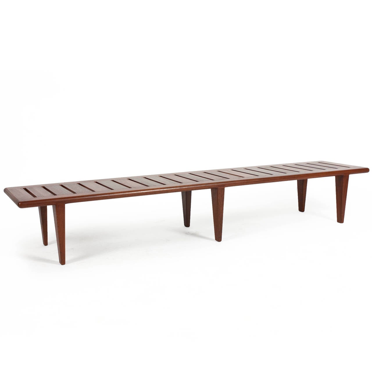 A long Hans J. Wegner slatted teak bench. 

Designed by Hans J. Wegner 1958, made by cabinetmaker Johannes Hansen. 

A simple and rare piece in fine original condition.