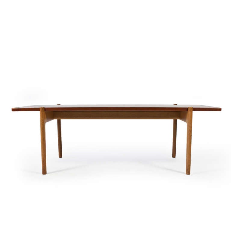 Hans J. Wegner coffee table with reversible top of teak and black formica. 

Frame of original patinated oak. 

Manufactured by cabinetmaker Johannes Hansen, Denmark. 

Good condition with light patina.