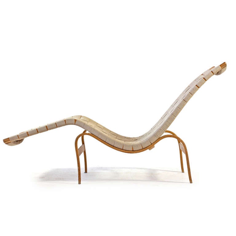 Sculptural Bruno Mathsson lounge chair with frame of bended patinated beech, woven canvas webbing. 

Designed 1936, manufactured by Karl Mathsson, Sweden model 36. Burn Marked. 

Sold from Illums Bolighus, Copenhagen with metal tag.

Good