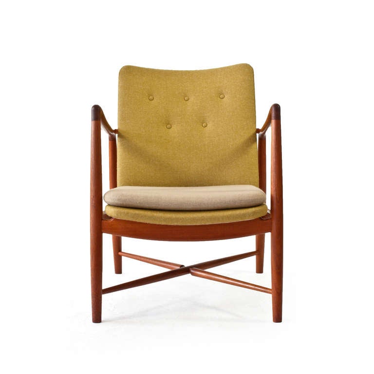 Finn Juhl teak easy chair, model BO46 with cross bars under seat. 

Frame of solid, original patinated teak and new two tone wool upholstery.  

Designed by Finn Juhl for Bovirke, Denmark.