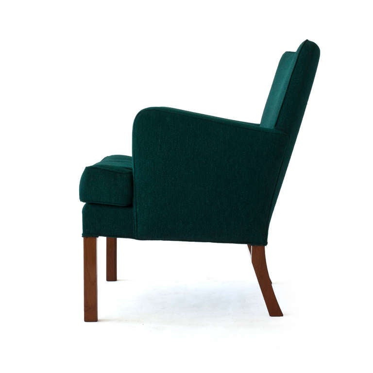 Kaare Klint armchair with loose down filled seat cushion, legs of mahogany. Upholstered with original green fabric. 

Manufactured by Rud. Rasmussen, Copenhagen model KK 5313. 

The chair was designed for the Danish 'Sadelmager- og