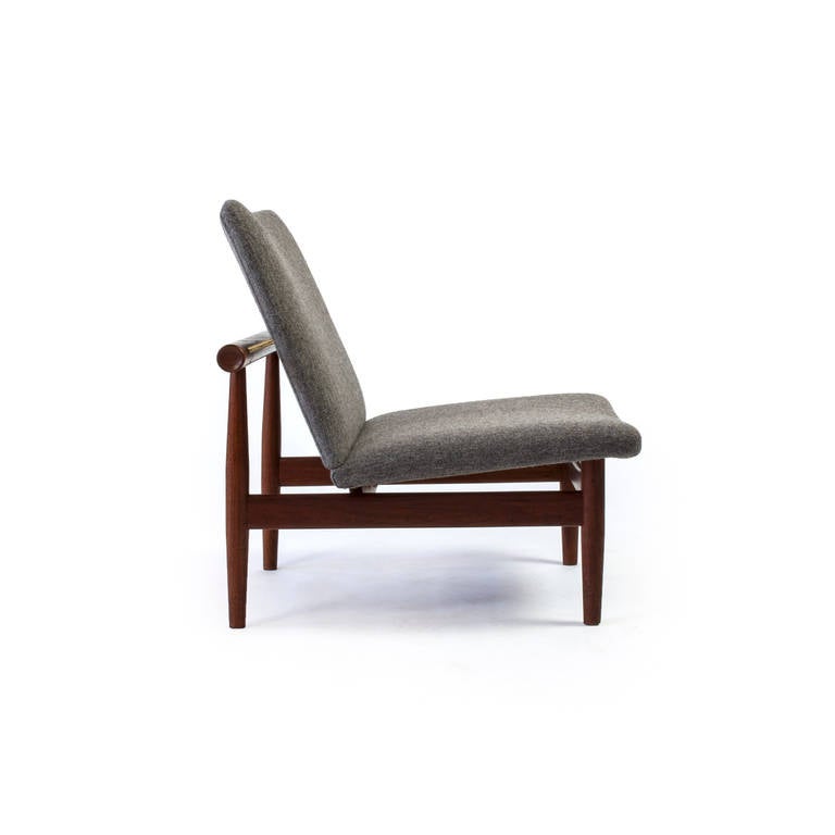 The minimalistic and beautiful Japan chair by Finn Juhl. 

Solid teak frame with natural patina, brass stretchers and new upholstery with grey hand-stiched wool. 

Manufactured and marked by France & Son, Denmark.