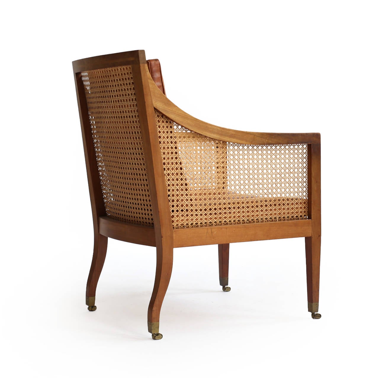 Kaare Klint 'Bergere' chair. 

Mahogany frame with rosewood inlays, woven French-style cane and brass casters. Original loose cushions upholstered with Niger leather. 

Designed by Kaare Klint, 1932, manufactured and marked by cabinetmaker