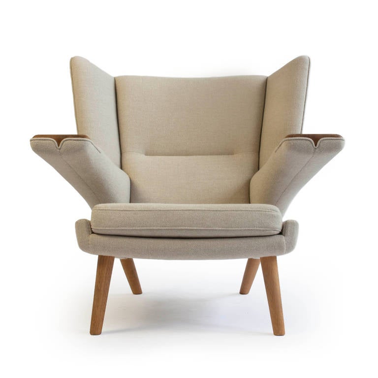 A rare Hans J. Wegner bear chair with legs and exposed arms of oak. 

New Beige wool upholstery. 

Designed by Hans J. Wegner 1968 for AP Stolen. 

This chair sold from cabm. Johannes Hansen's studio in Copenhagen, original metal tag still