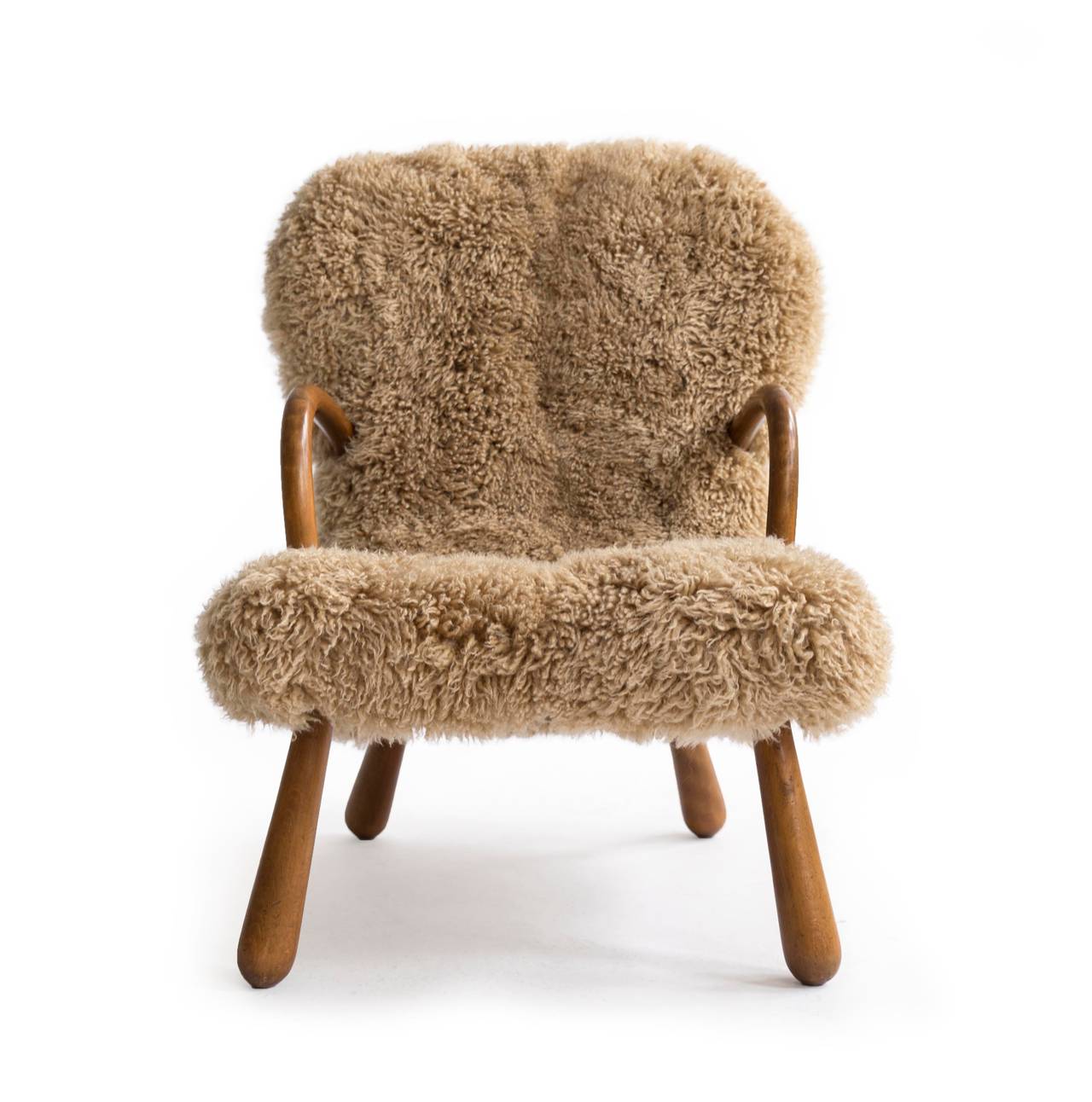 Expressive lounge chair with arms and legs of stained beech upholstered with  brown long haired lambskin. 

Made and designed by unknown Danish cabinetmaker app. 1940s. 

Fine condition.