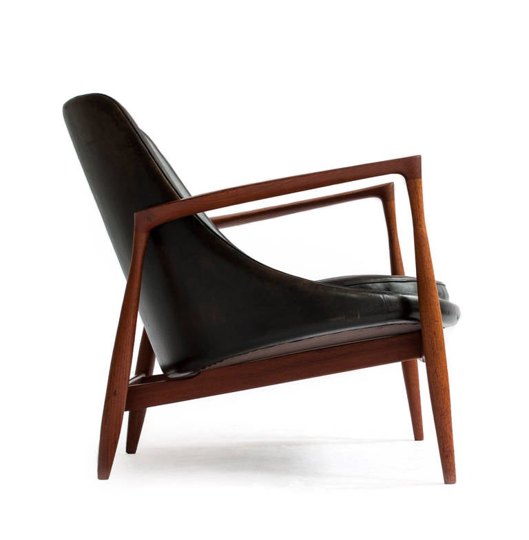 Ib Kofod-Larsen 'Elizabeth' chair with exposed teak frame, upholstered with original black dyed natural leather. 

Designed by Ib Kofoed Larsen 1956, executed and marked by cabinetmakers Christensen & Larsen, Denmark. Model U-56.

Original