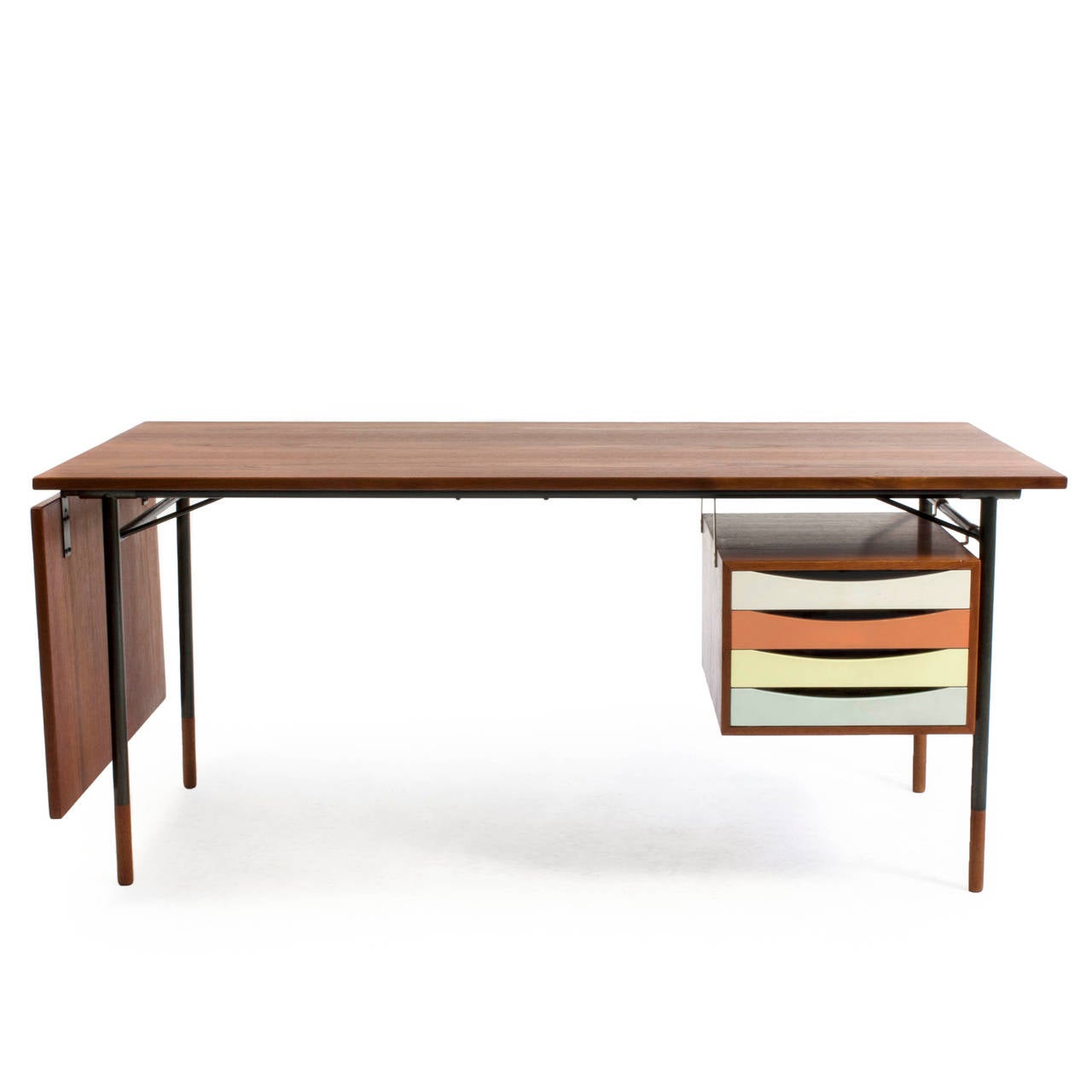 A rare freestanding Finn Juhl teak desk with colored drawers and detachable flip-down leaf. 

Drawer section, tabletop and shoes of teak, frame of gunmetal. 

Designed by Finn Juhl 1953 and manufactured by Bovirke, Denmark, model BO 69. 

Burn