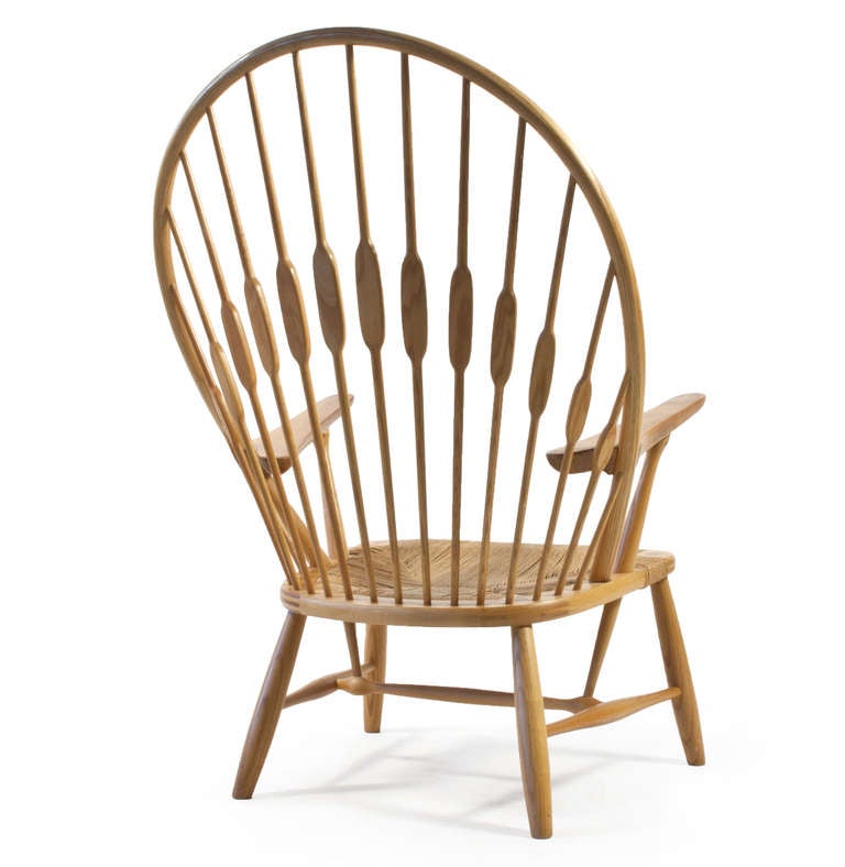 Hans J. Wegner 'The Peacock chair' in original patinated ash, arms of teak and seat of patinated paper cord. 

Designed in 1947 by Hans J. Wegner and manufactured by Johannes Hansen in Denmark. Burn-marked.

A pair is available.