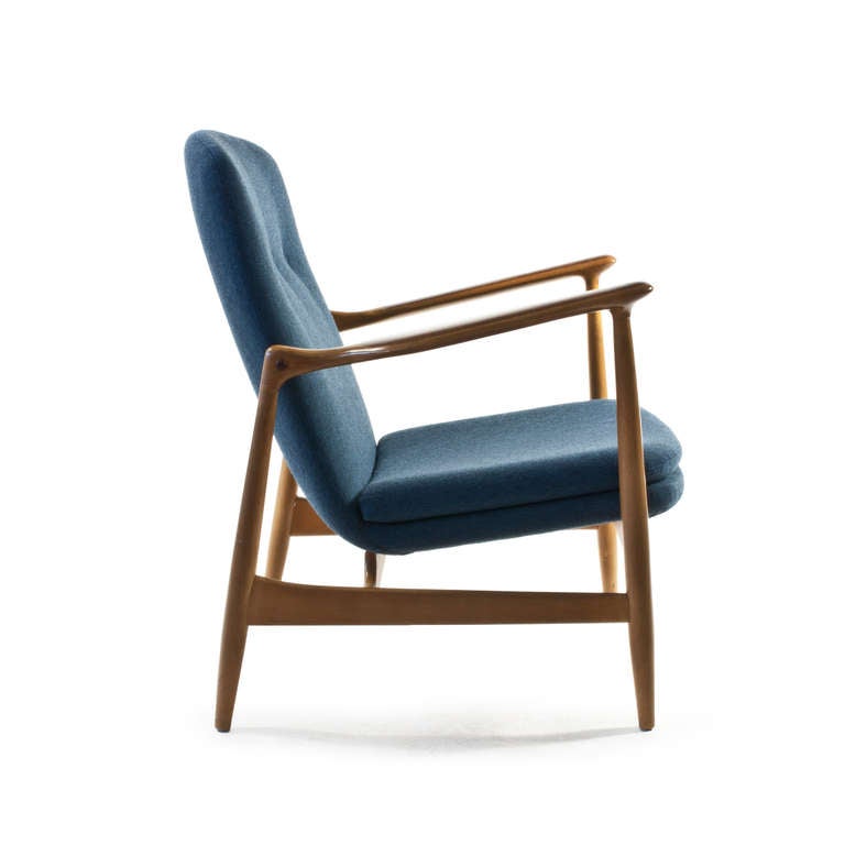 Finn Juhl fireplace chair with frame of patinated beech and inlays of Rosewood.  

Upholstered with original blue fabric.  Designed by Finn Juhl 1952, Manufactured by Bovirke, Denmark.

Fine condition.