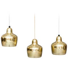 "Golden Bell" pendents by Alvar Aalto for Louis Poulsen.