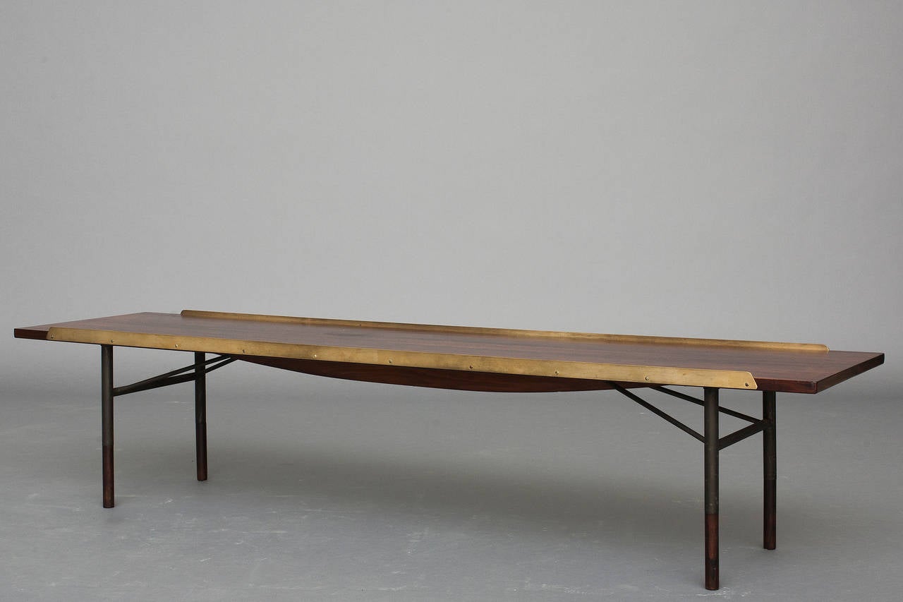 Table / bench, model: BO 101 by Finn Juhl for Bovirke.
Design 1953
Rosewood, raised polished brass edges, legs of anodized metal, shoes of rosewood.
Nice original condition.
Long version.