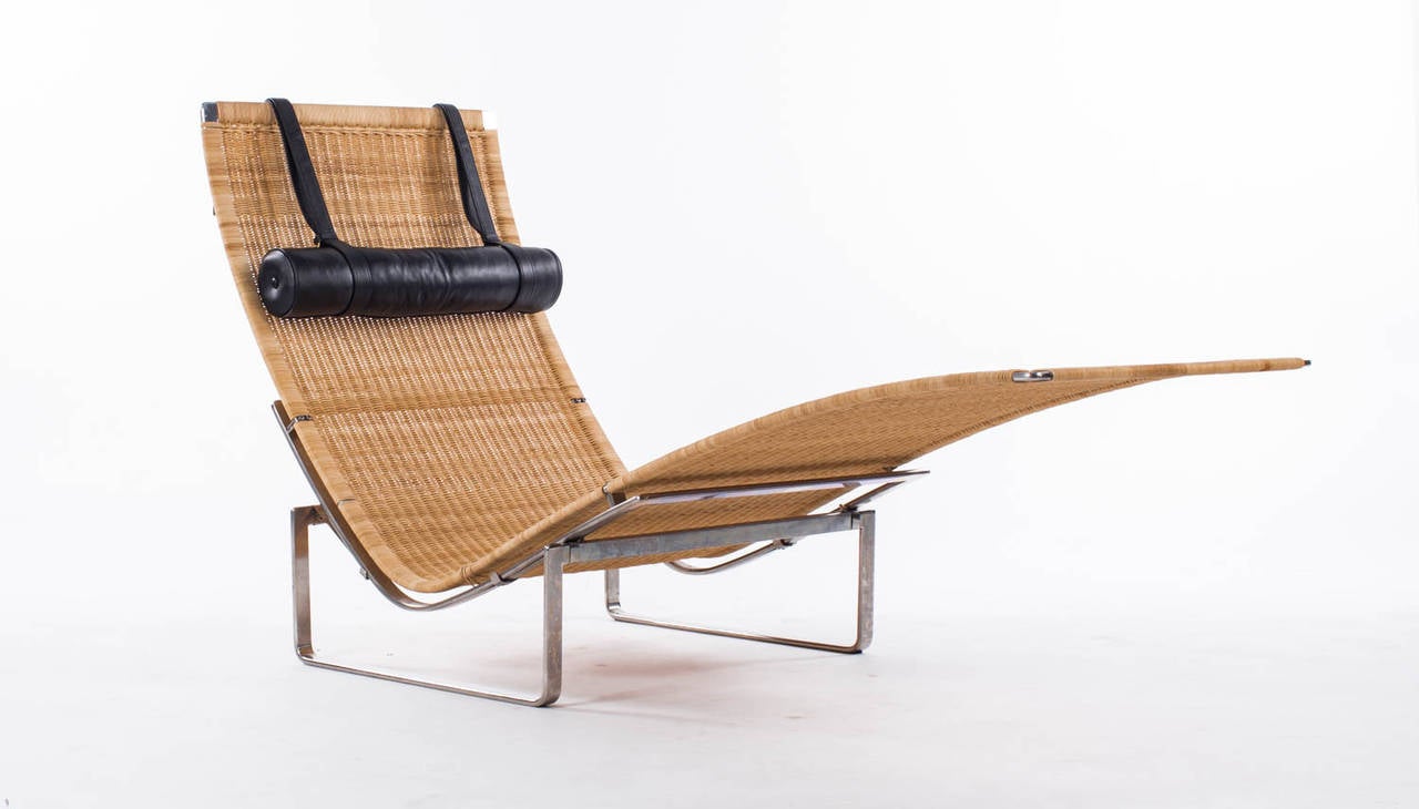 PK 24 chaise longue with stainless steel frame, seat and back of woven original cane, neckrest upholstered with original black leather, designed 1965.
Manufactured by E. Kold Christensen.