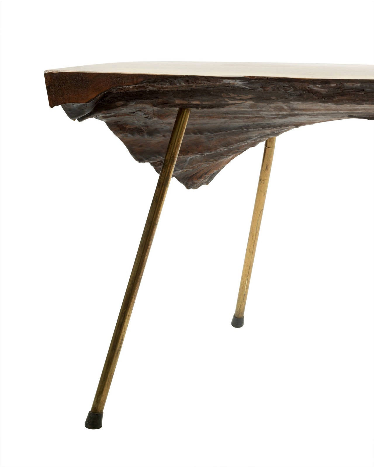 A solid walnut coffee table raised on three brass legs