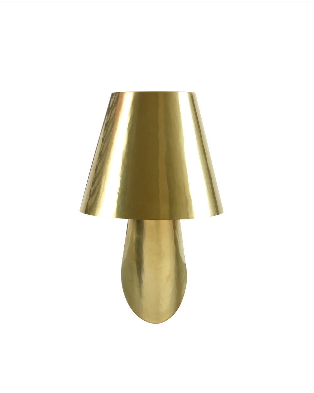 An unique pair of wall lamps of hammered and polished brass.