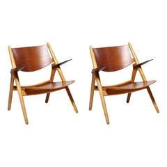 A pair of sawbuck easy chairs