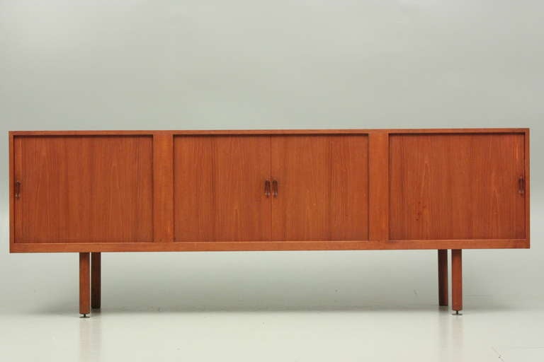 Large low credenza with roll front and brass details. Manufactured by Næstved Møbelfabrik, Denmark. Designed by E.Larsen and A.B.Madsen.