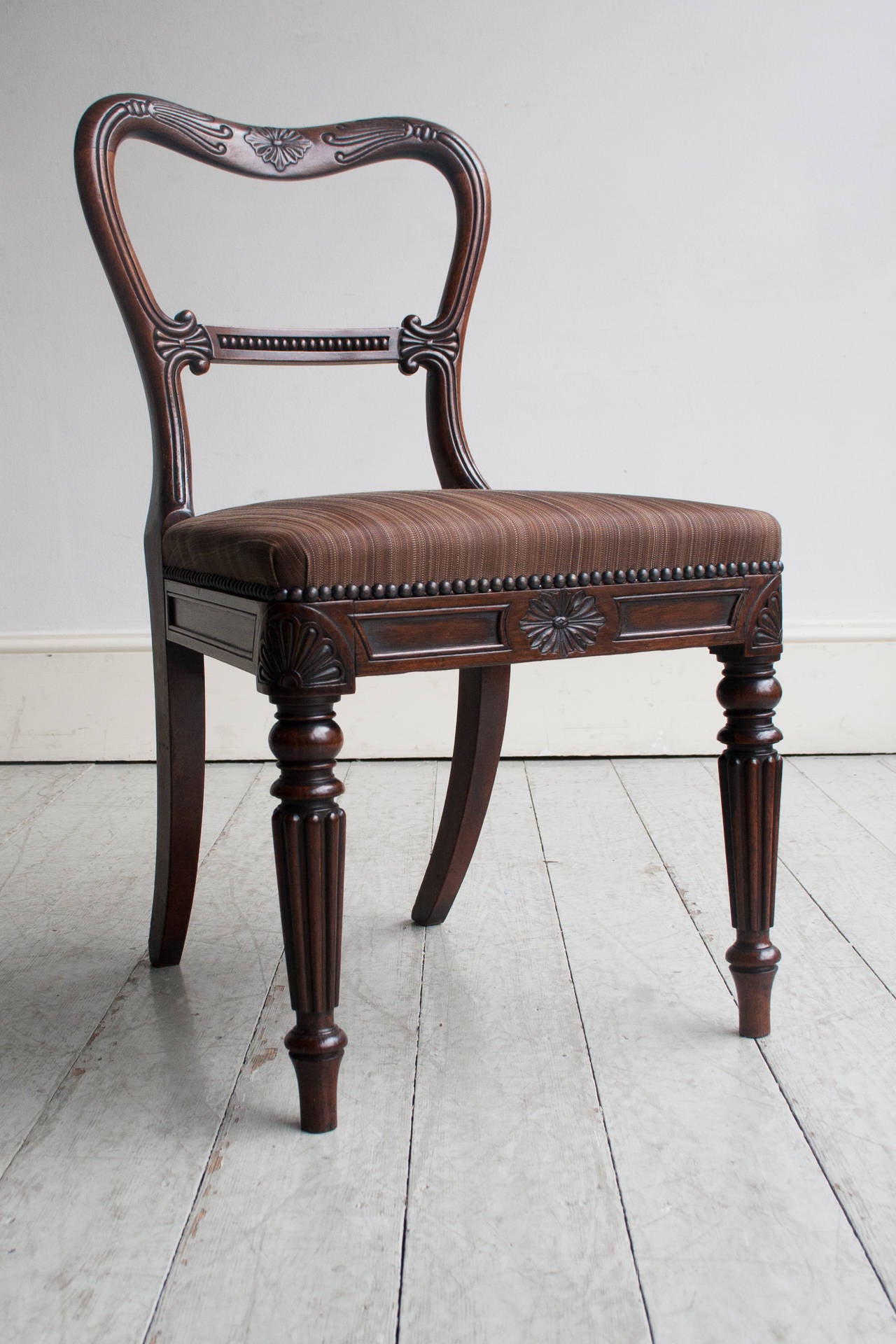 in the best quality rosewood and of exceptional quality, colour and original condition, the seat rails stamped 'E L' with the remains of paper label 'R & Newton Upholstery,' having been re-upholstered in brown woven horse-hair fabric. By Gillow of