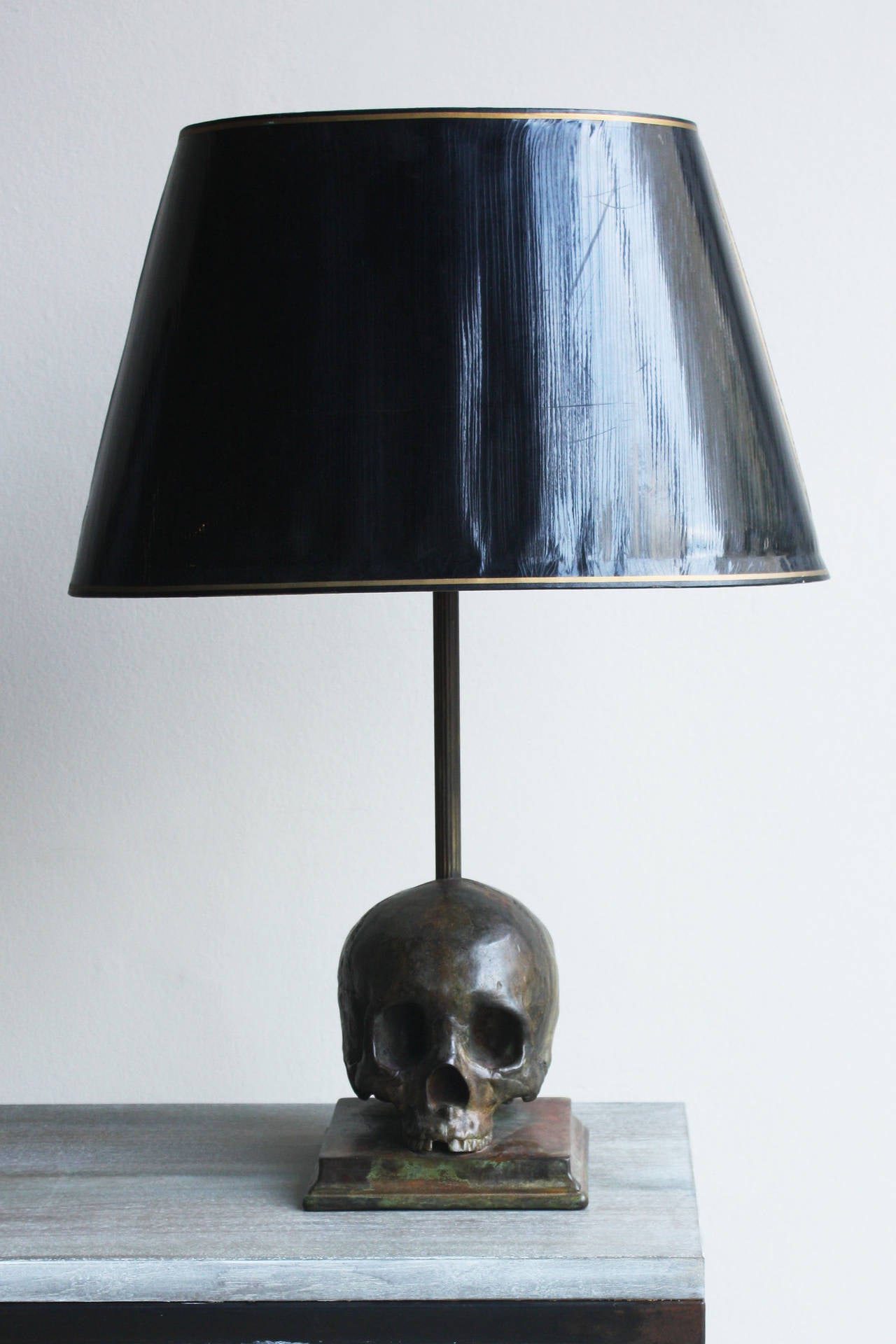 Cast and patinated in one of the best London art foundries, fitted (if wanted) with a pair of vintage black lacquered card oval lampshades. Made to order