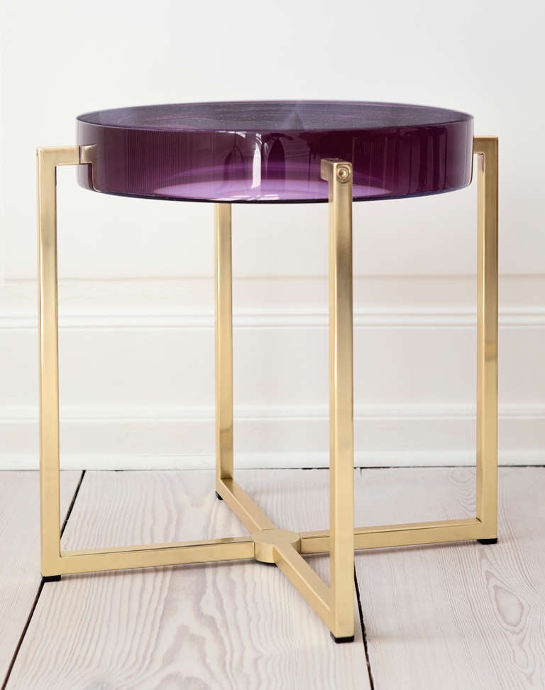 Lens table with amethyst tinted resin top backed by acrylic mirror on brass base.