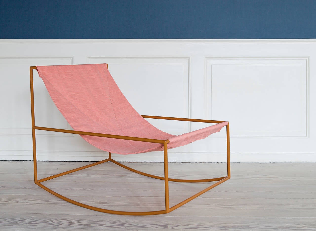 Rocking chair in lacquered steel and slung textile.