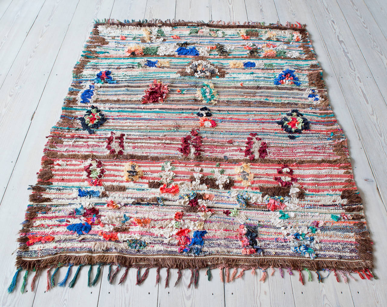 Beautiful berber kilim rug. Brown border and multicolor pattern and tassels.