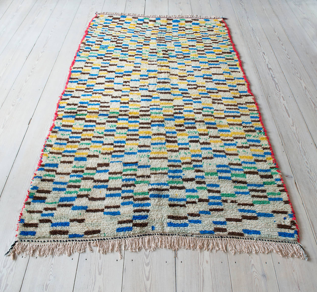 Beautiful Azilal rug in a multicolor pattern and with ivory tassels.