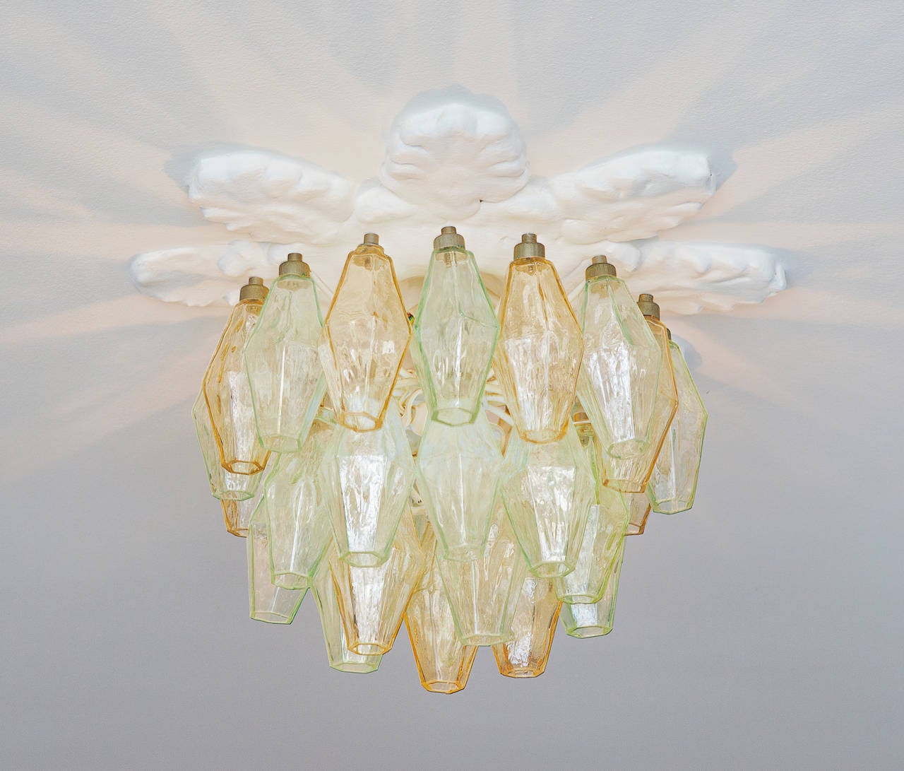 Beautiful vintage Venini polyhedral chandelier. Clear and tinted glass in shades of yellow and turquoise. Brass fittings.