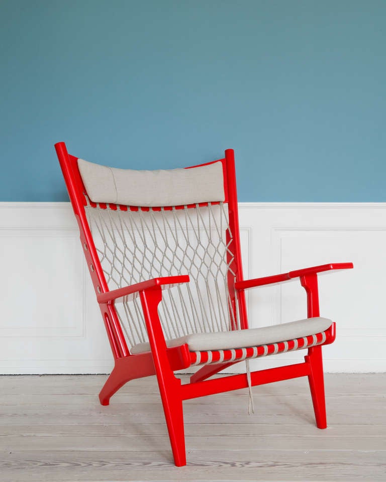 PP129 Arm Chair in red lacquered ash wood, flag halyard, neck and seat cushion in linen.  Designed in 1968 by Hans J. Wegner.