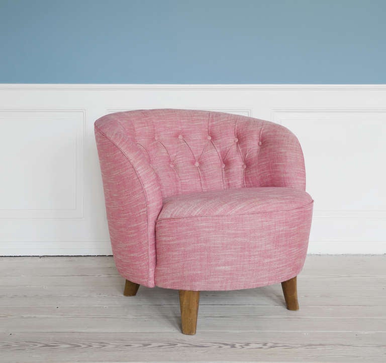 Swedish 1940's lounge chair in new pink upholstery. Wooden legs.