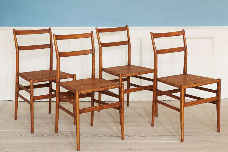 Four Gio Ponti Superleggera chairs in superbly patinated ash wood and cane.