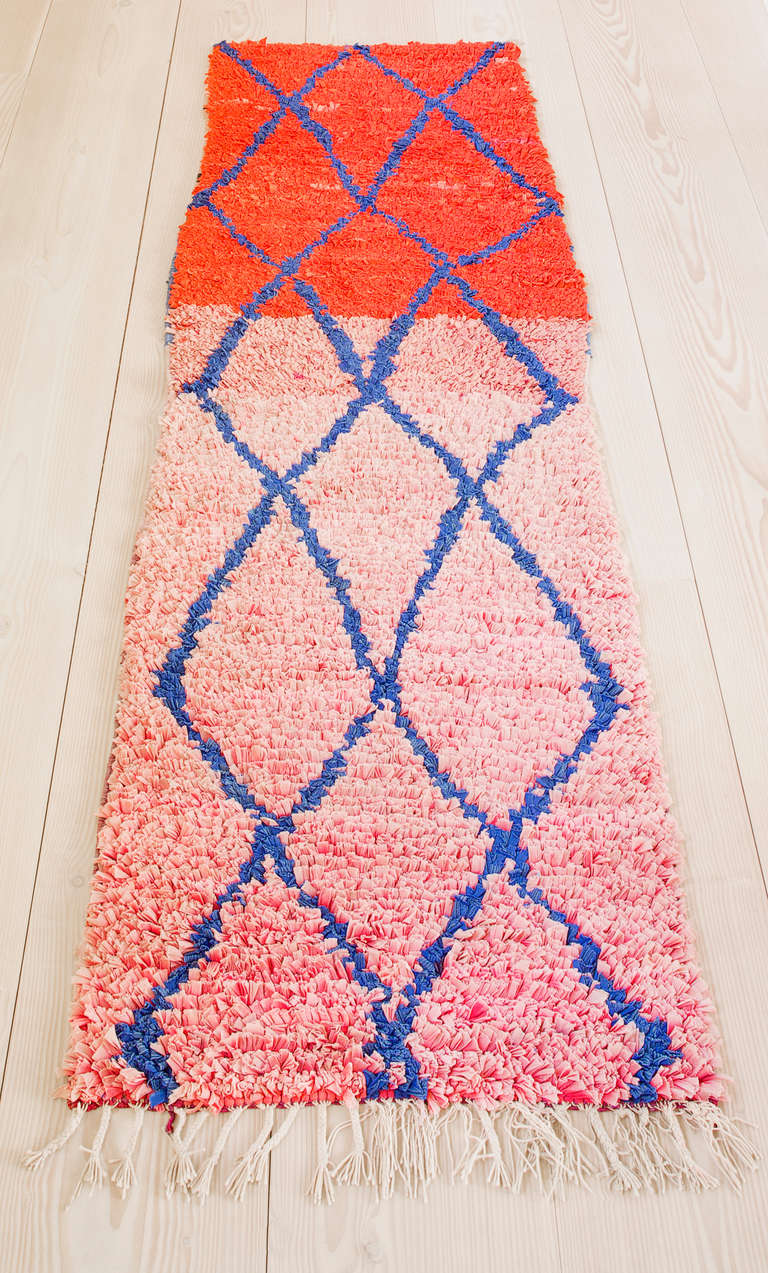 Lovely Boucherouite rag rug. Bright blue lozenge pattern on pink and red background.