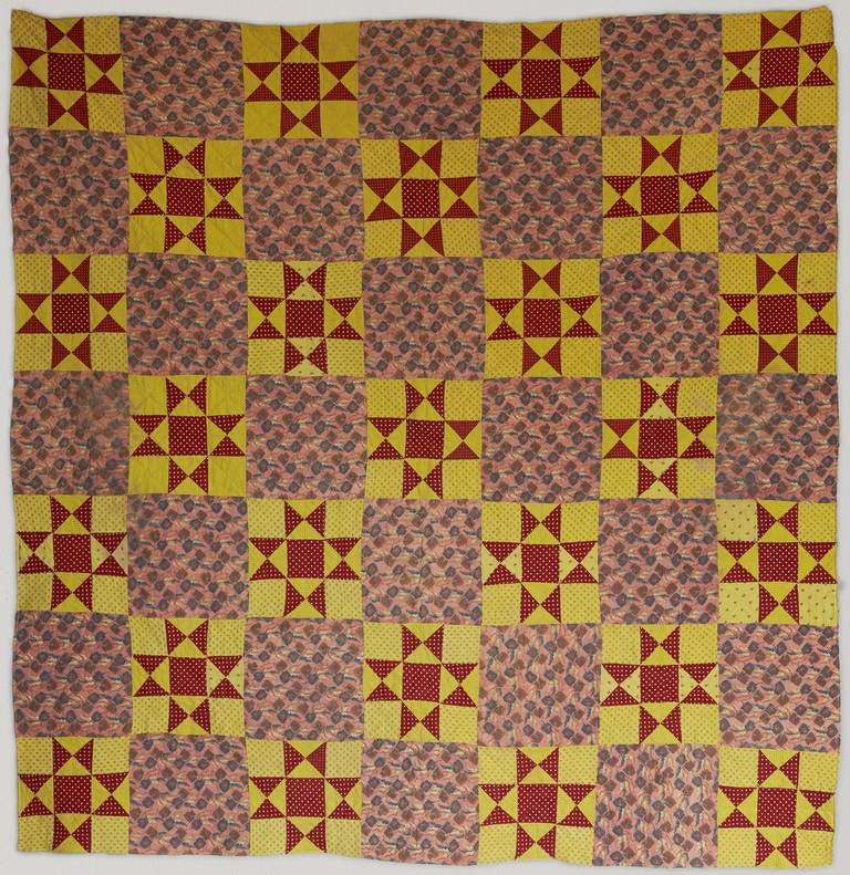 American vintage patchwork quilt. Star pattern in red, yellow and floral textile.