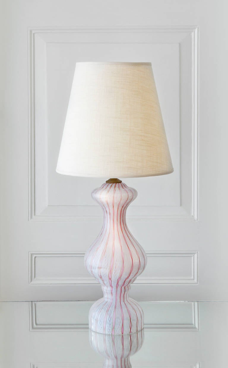 Elegant shaped table lamp in pink and white tinted glass.