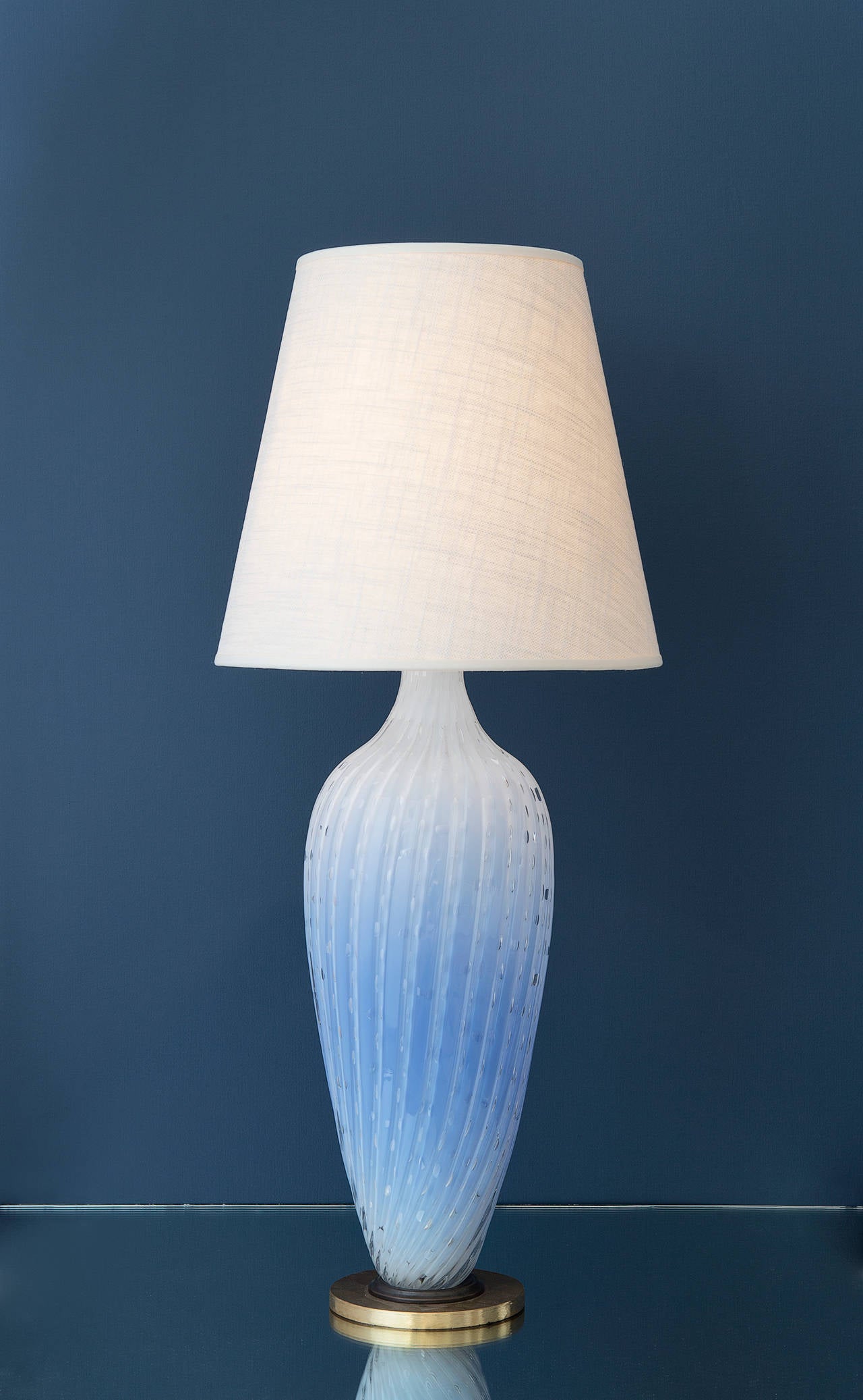 Exquisite Murano table lamp in dotted light blue glass and brass base. New linen shade.