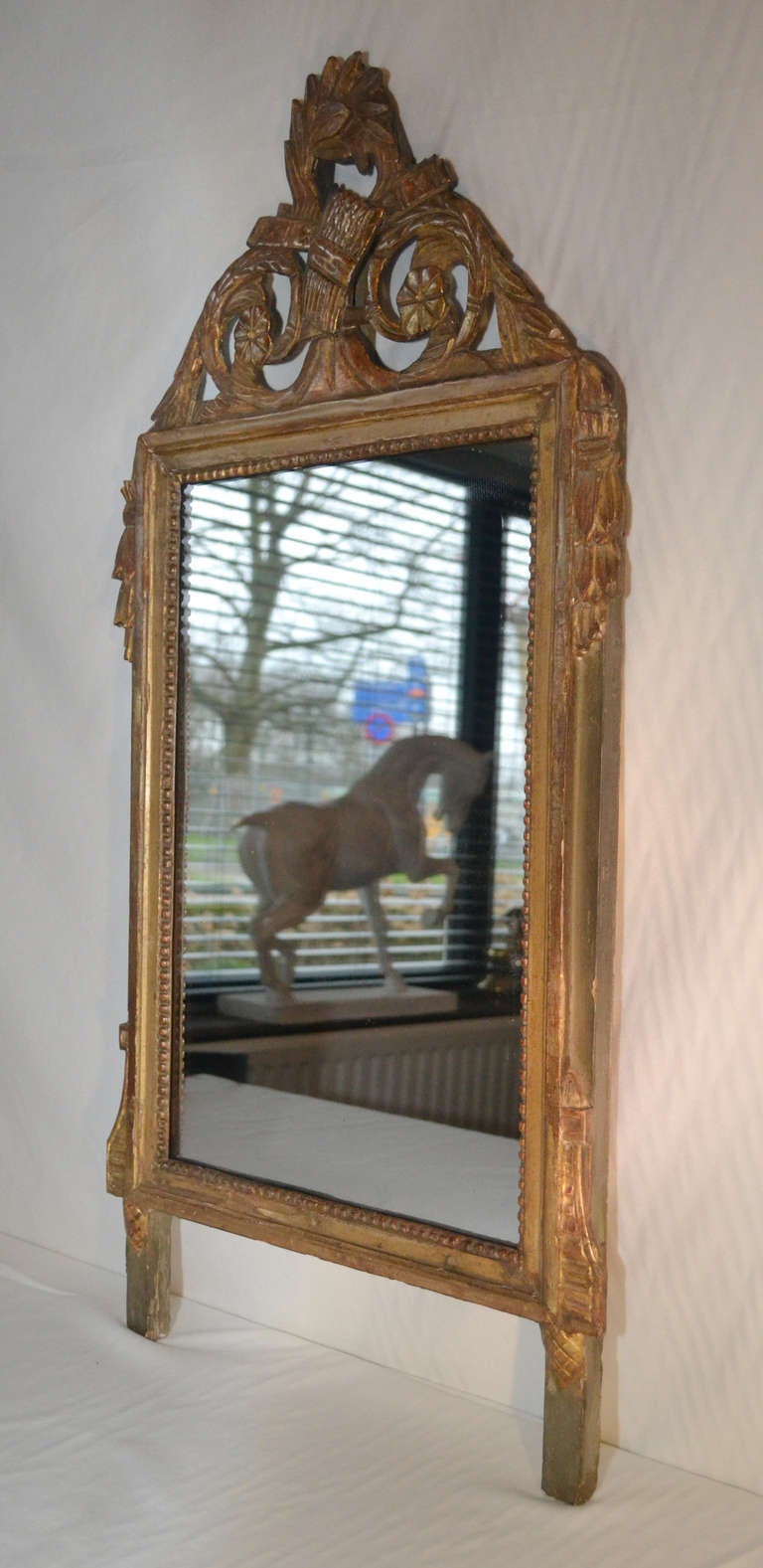 Woodcarved and gilded mirror.