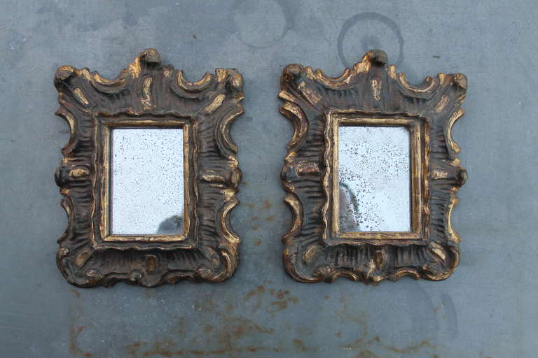 A pair of small 18th century, wood-carved, Italian polychromed and gilded
mirrors. Original glass.